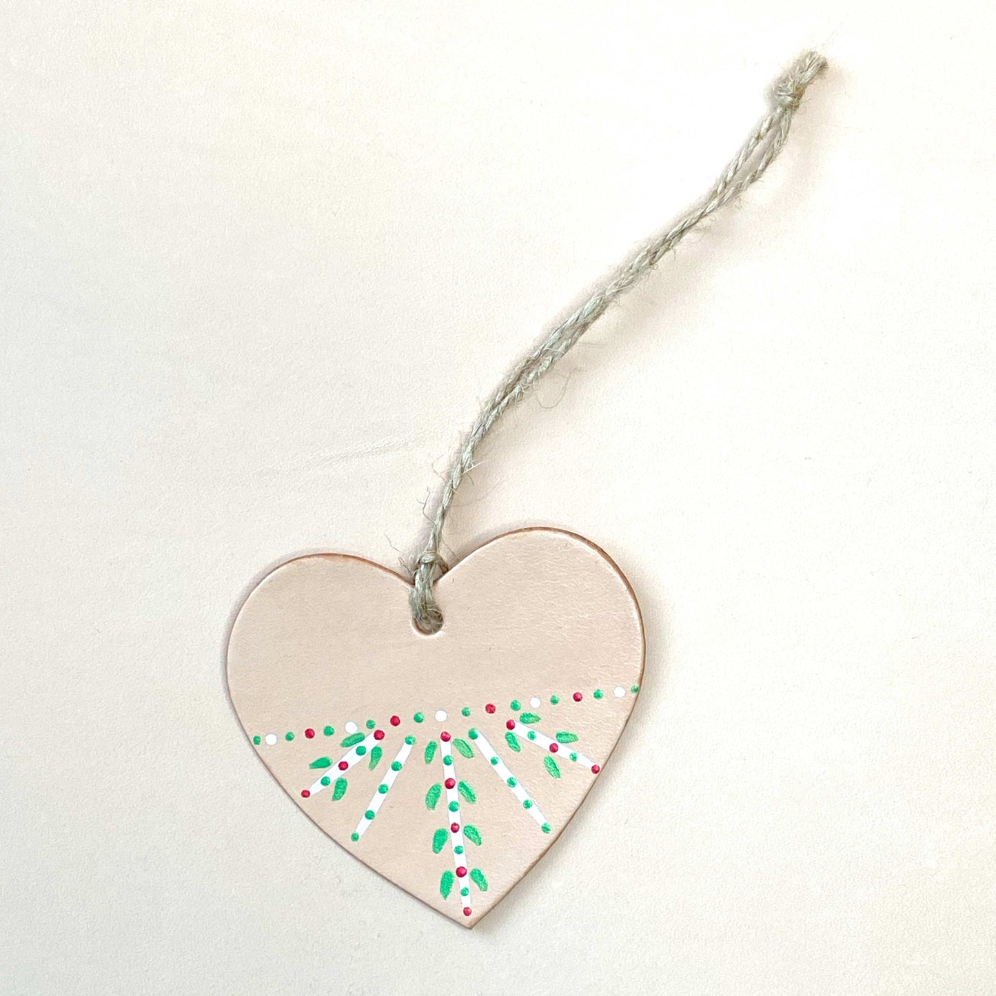 Heart shaped Christmas decoration painted with a folk inspired pattern
