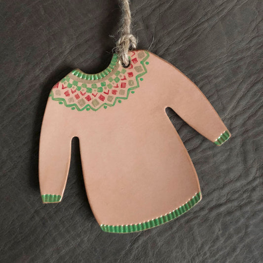 A Christmas jumper decoration painted with a green geometric design