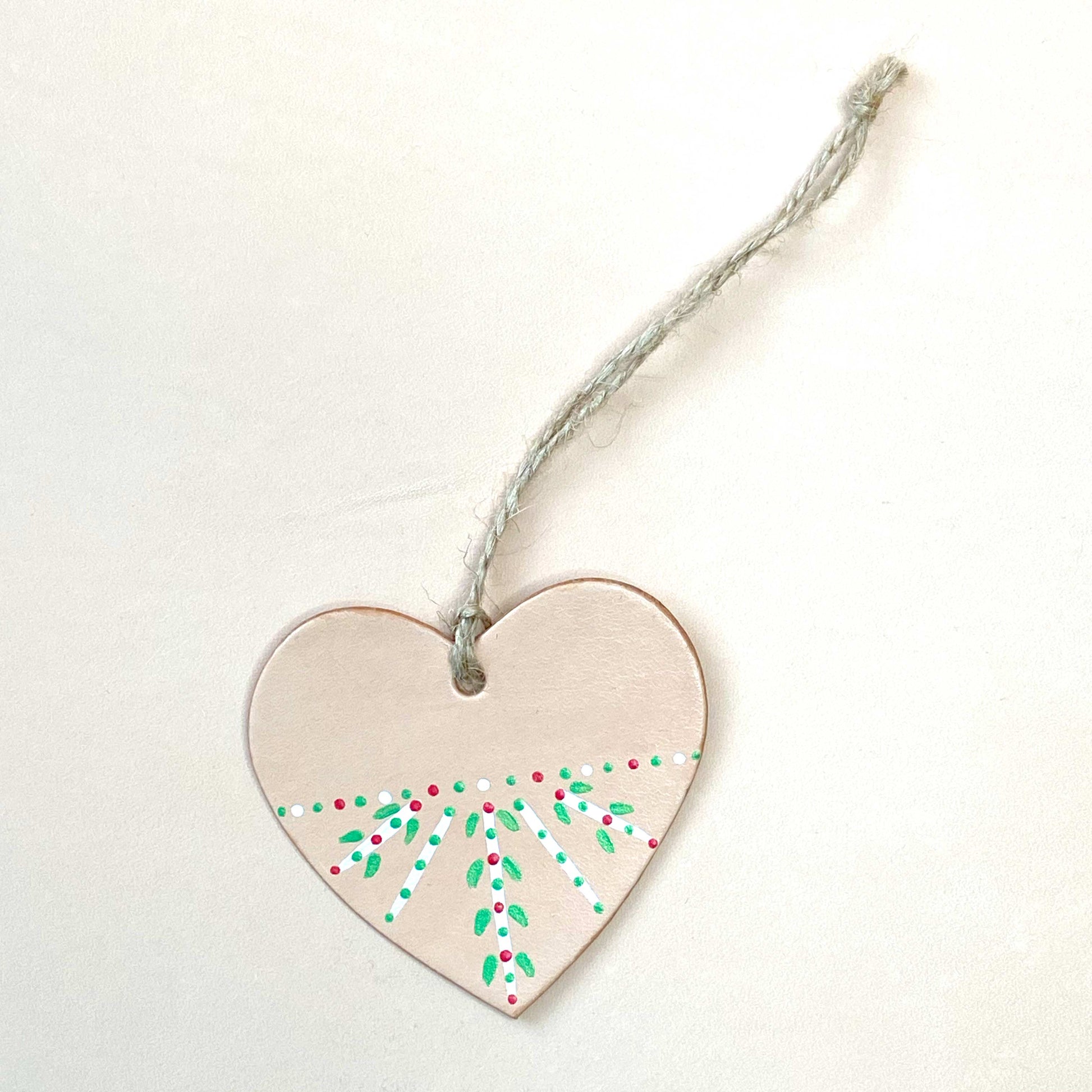 Heart shaped Christmas decoration painted with a folk inspired pattern
