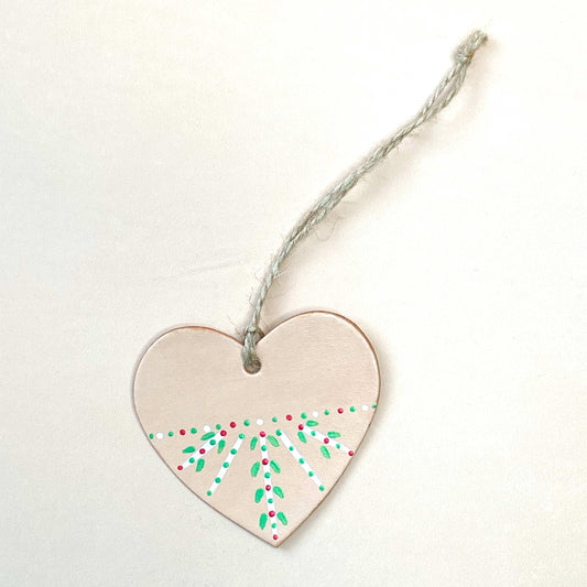 Heart shaped Christmas decoration painted with a folk inspired pattern